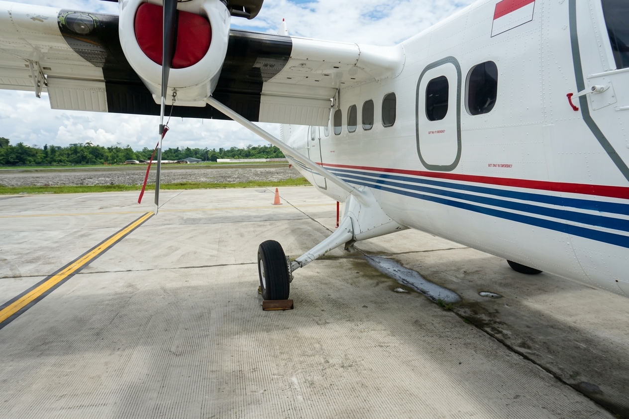 Close view of the Twin Otter on an apron with an Indonesian flag on the fuselage