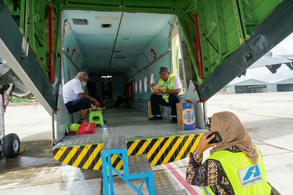 Kevinia Pramono-Rizqi beside an aircraft during AeroProc cargo operations