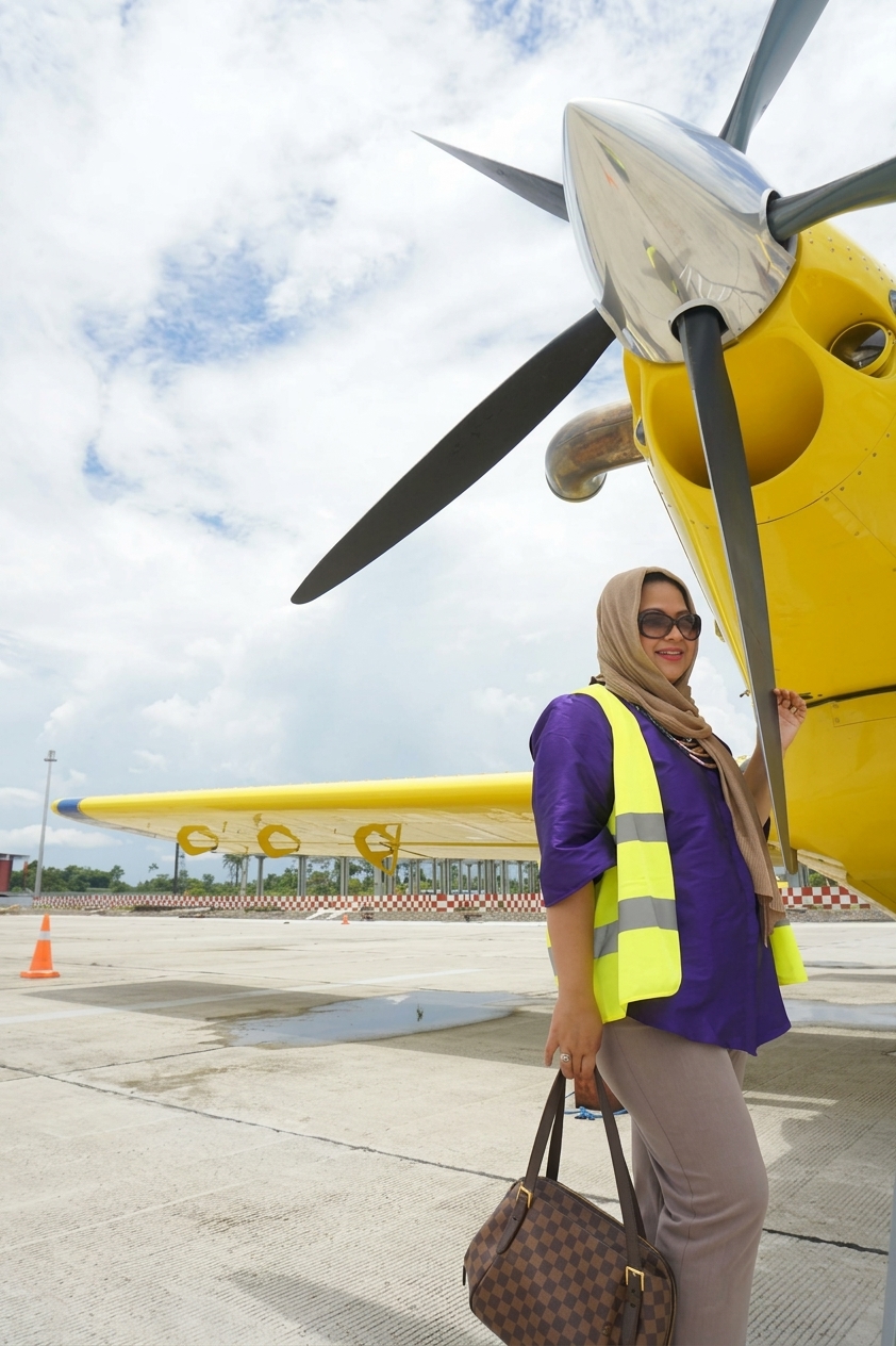 Kevinia Pramono-Rizqi beside the yellow FuelBoss aircraft